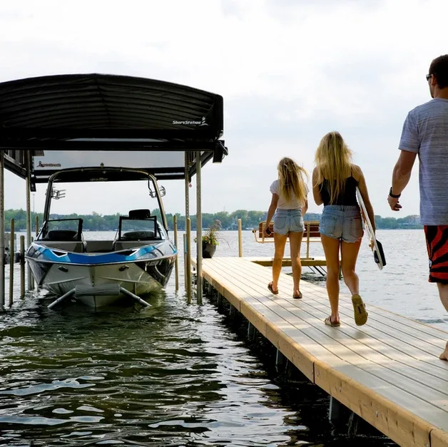 Family walking toward a boat in a ShoreStation lift